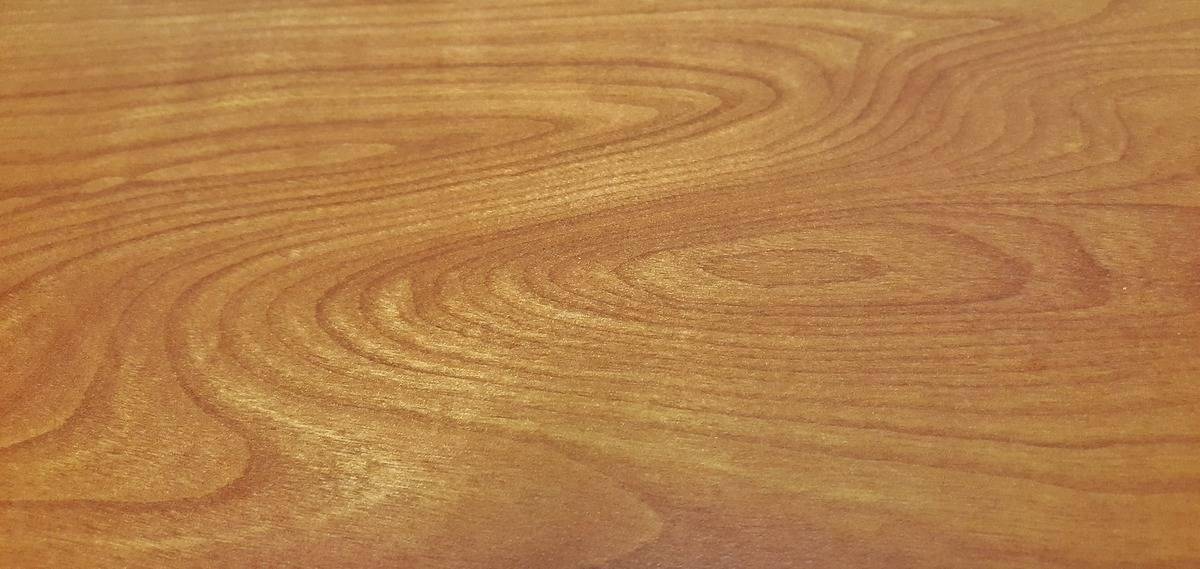 A close-up shows grains of wood.